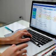 Expert creating a fitness plan on a laptop